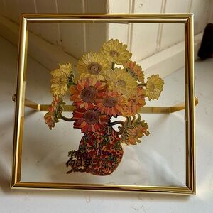 New in original package copper enamel sunflowers on glass in standing frame.